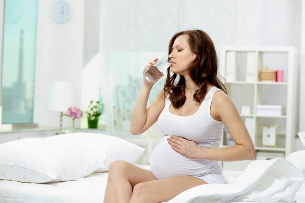 pregnant woman drinking electrolyte water