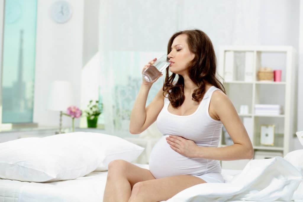 pregnant woman drinking water