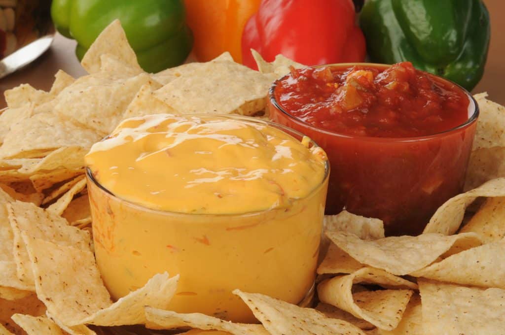Queso cheese dip and salsa dip with nachos