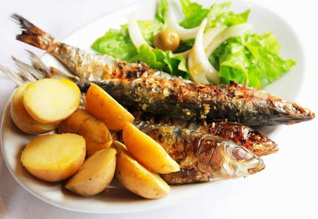 smoked grilled sardines with salad and potatoes