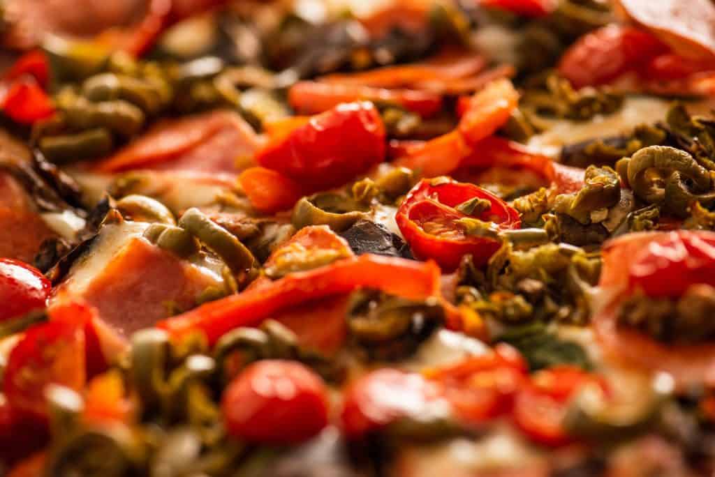 a close up picture of pizza toppings