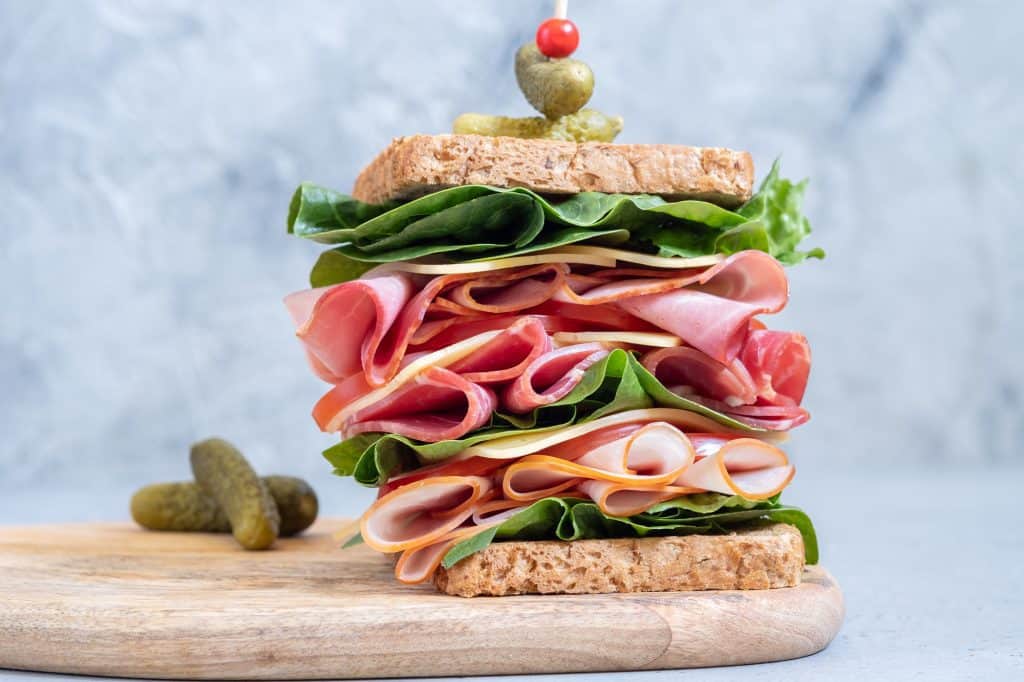 large deli sandwich with vegetables