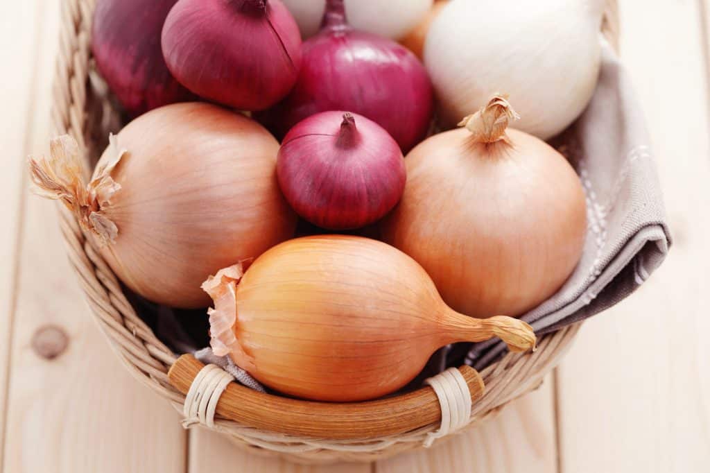 different types of onions in a basket