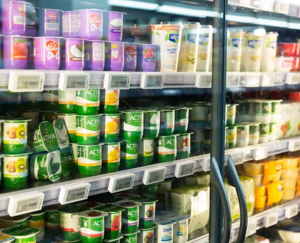 various yogurt brands in a fridge in a supermarket