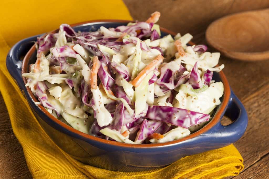 coleslaw with shredded cabbage, carrot, lettuce and mayonnaise in a bowl