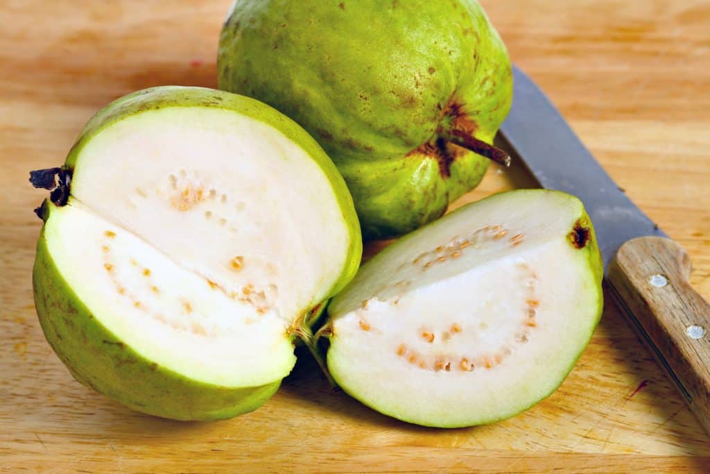 guava fruit cut open to show flesh and seeds