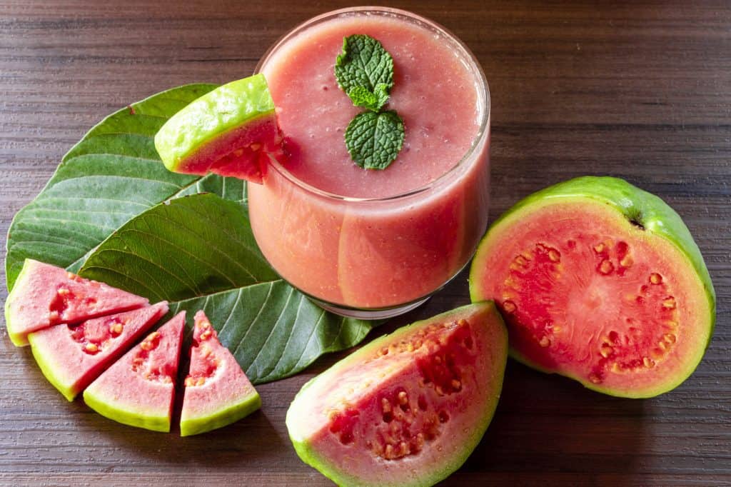 red guava juice with guava fruit and leaves