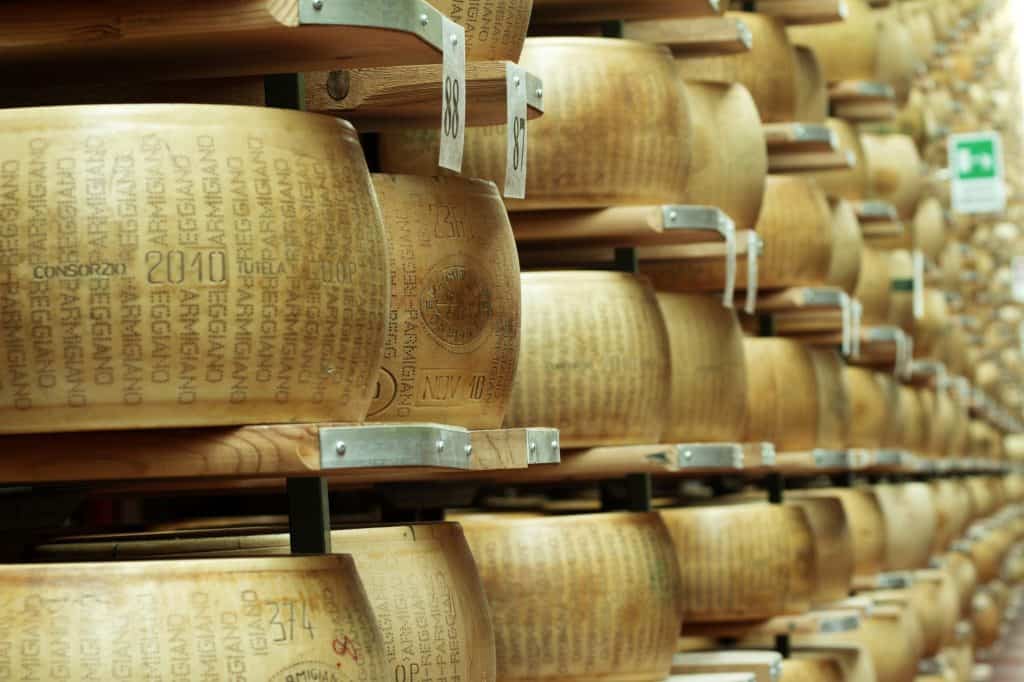 wheels of parmesan cheese on the racks of storehouse