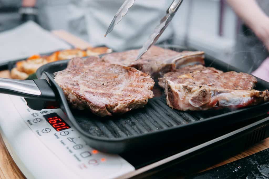 cooking steaks in pan