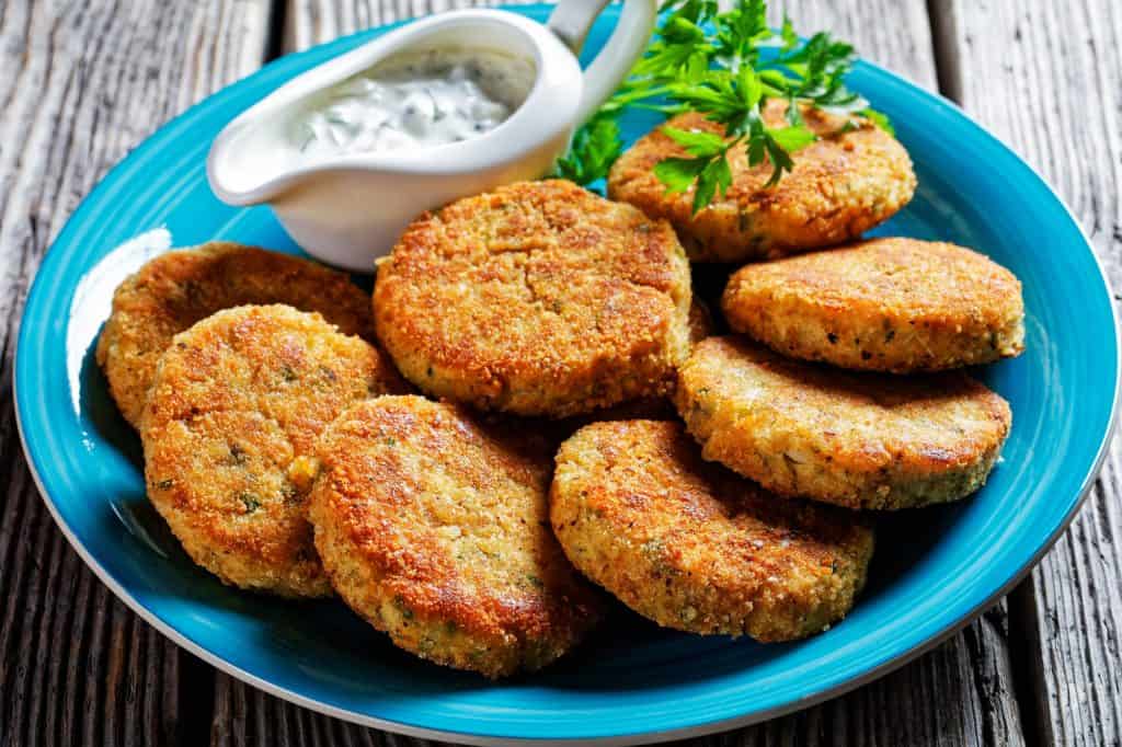 haddock fish cakes with dipping sauce on a plate 
