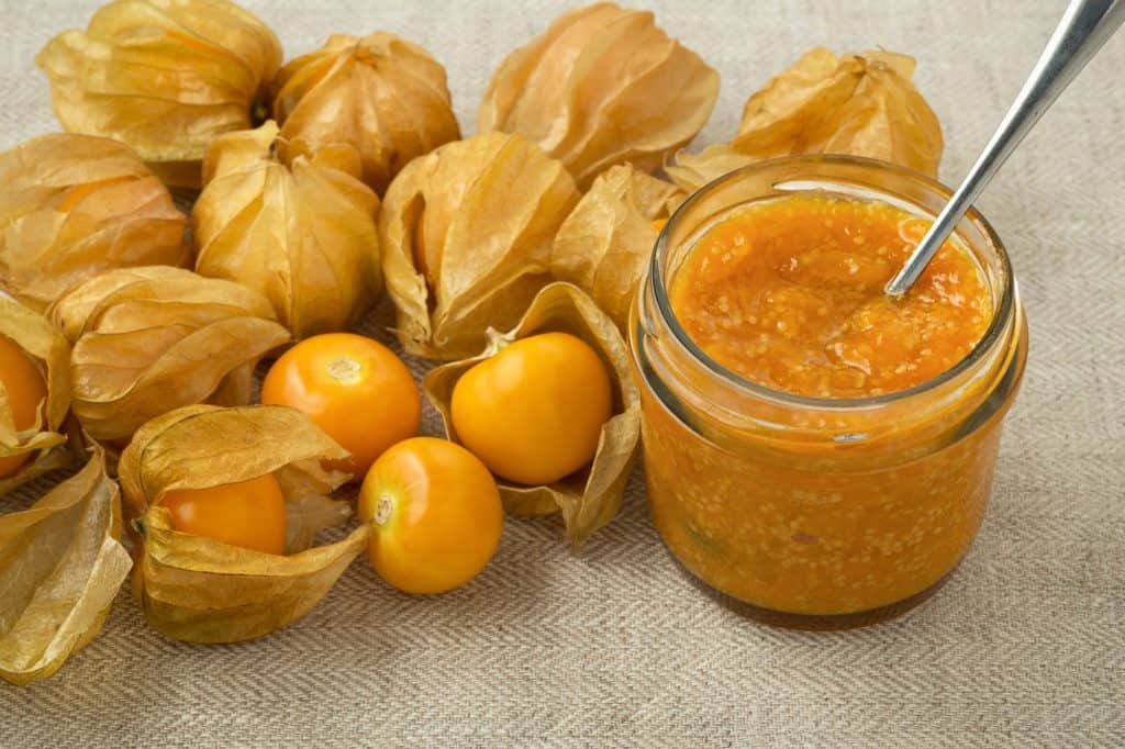 fresh cape gooseberries and gooseberry jam in a jar with spoon