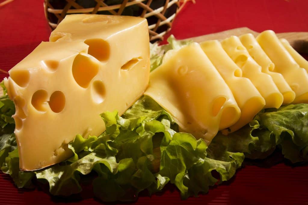 swiss cheese on lettuce leaves