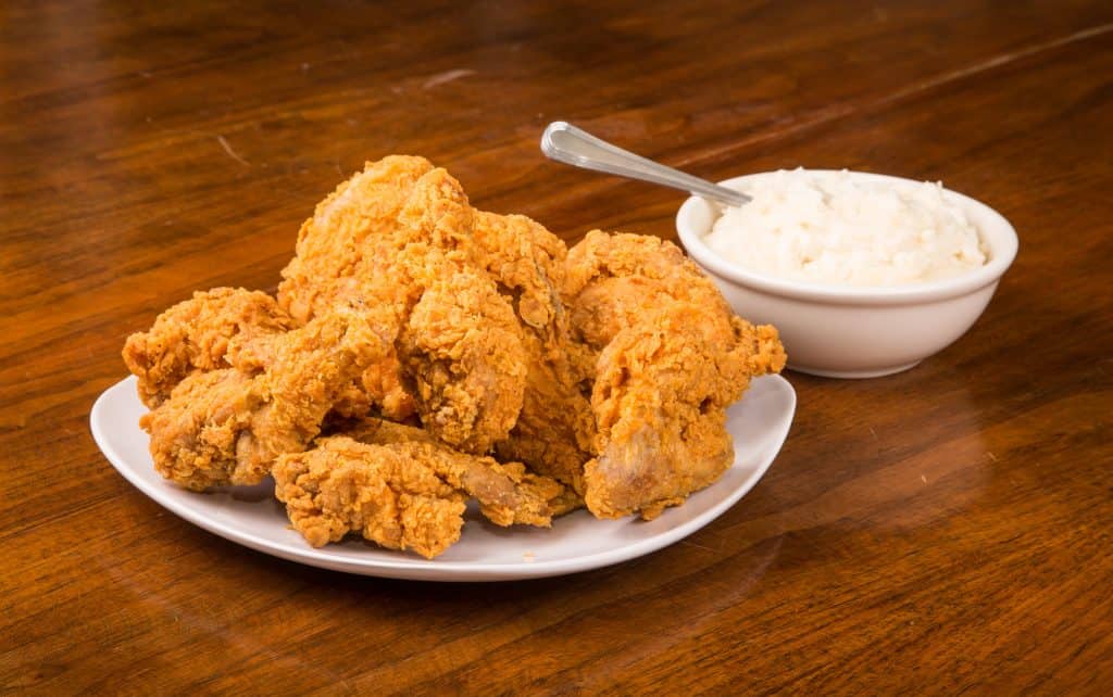 fried chicken in a plate and mashed potato in a bowl