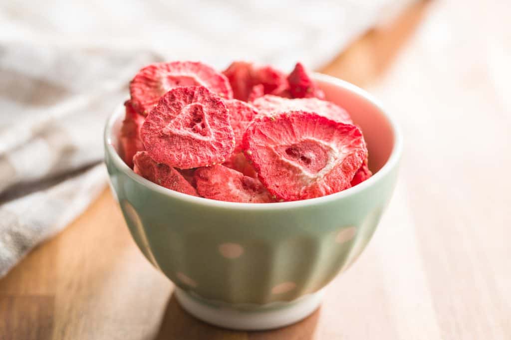 Freeze dried strawberry slices in bowl.